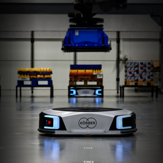 Robot drives through factory hall.