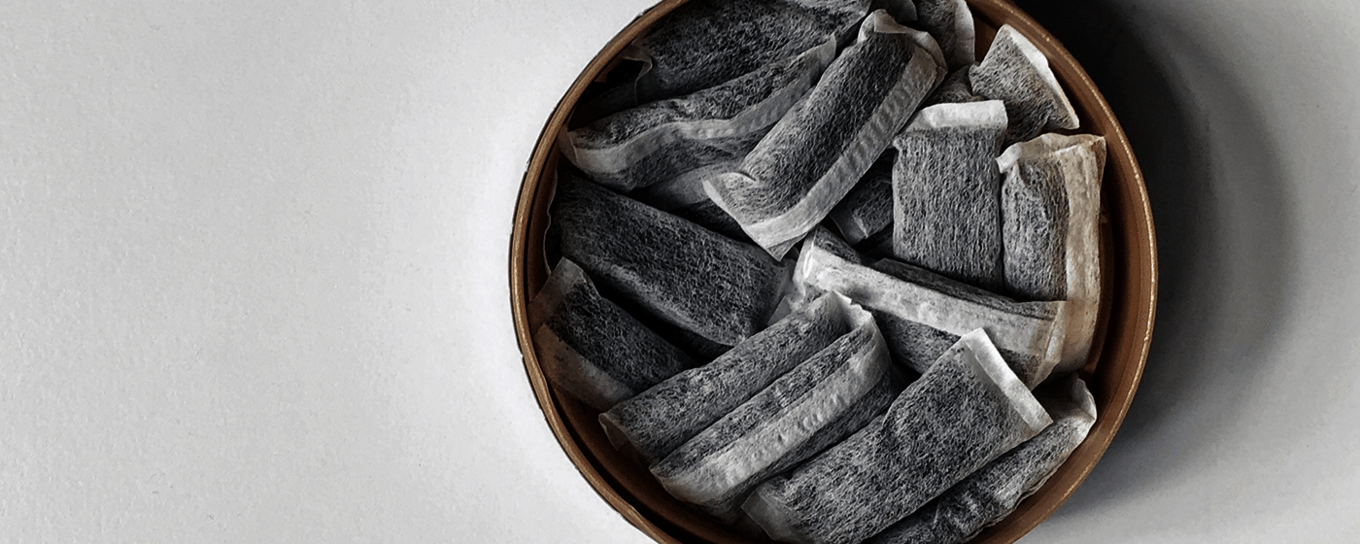 A collection of snus pouches arranged in a round container